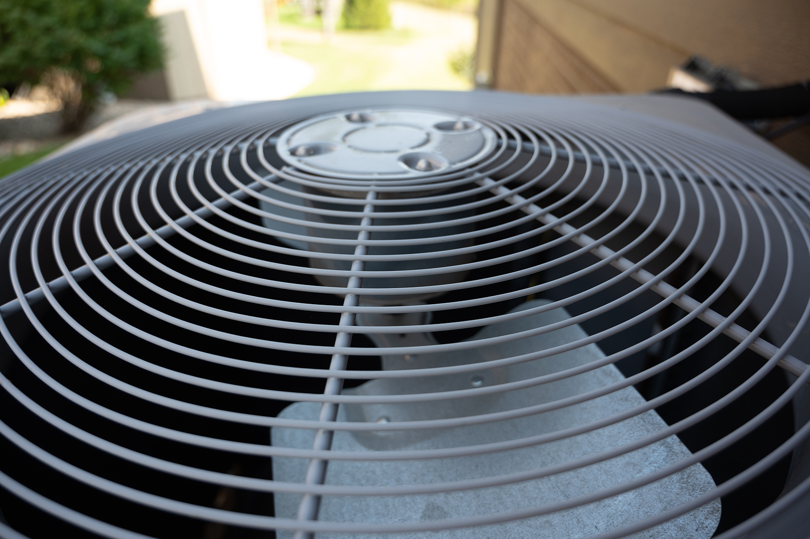 Top View Of Residential Air Conditioning Unit Outdoors With Fan
