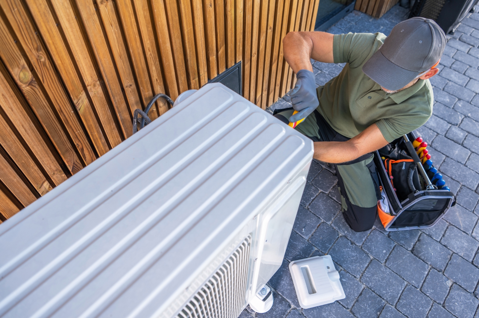 Hvac Tech Working On Air Conditioner Replacement In Wichita Ks
