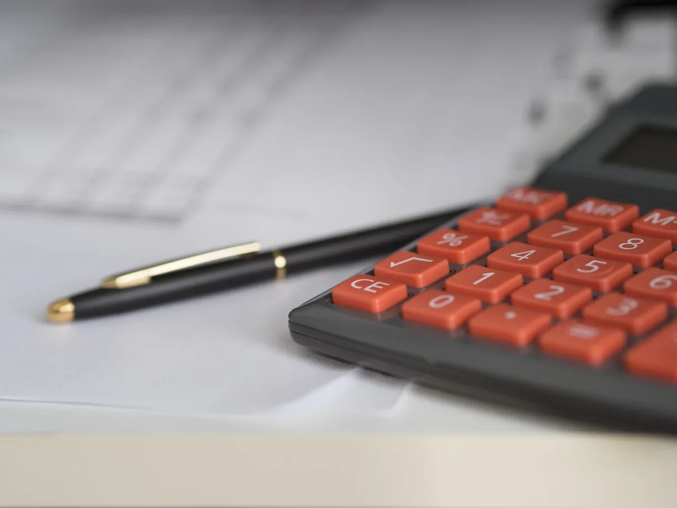 Calculator and pen on financial worksheets for HVAC cost planning