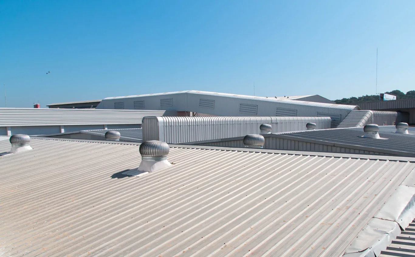 Turbine ventilation vents on a corrugated commercial metal roof