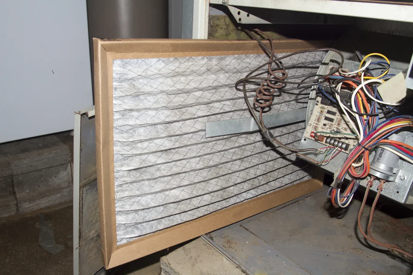 Dirty furnace filter being replaced with a clean one