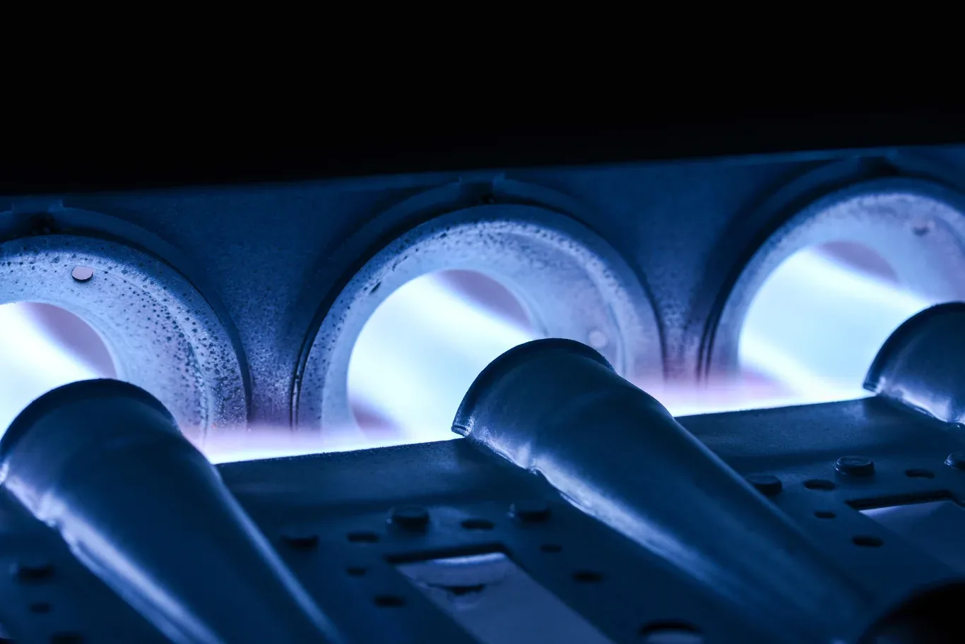 Close-up of blue flames on a gas furnace burner