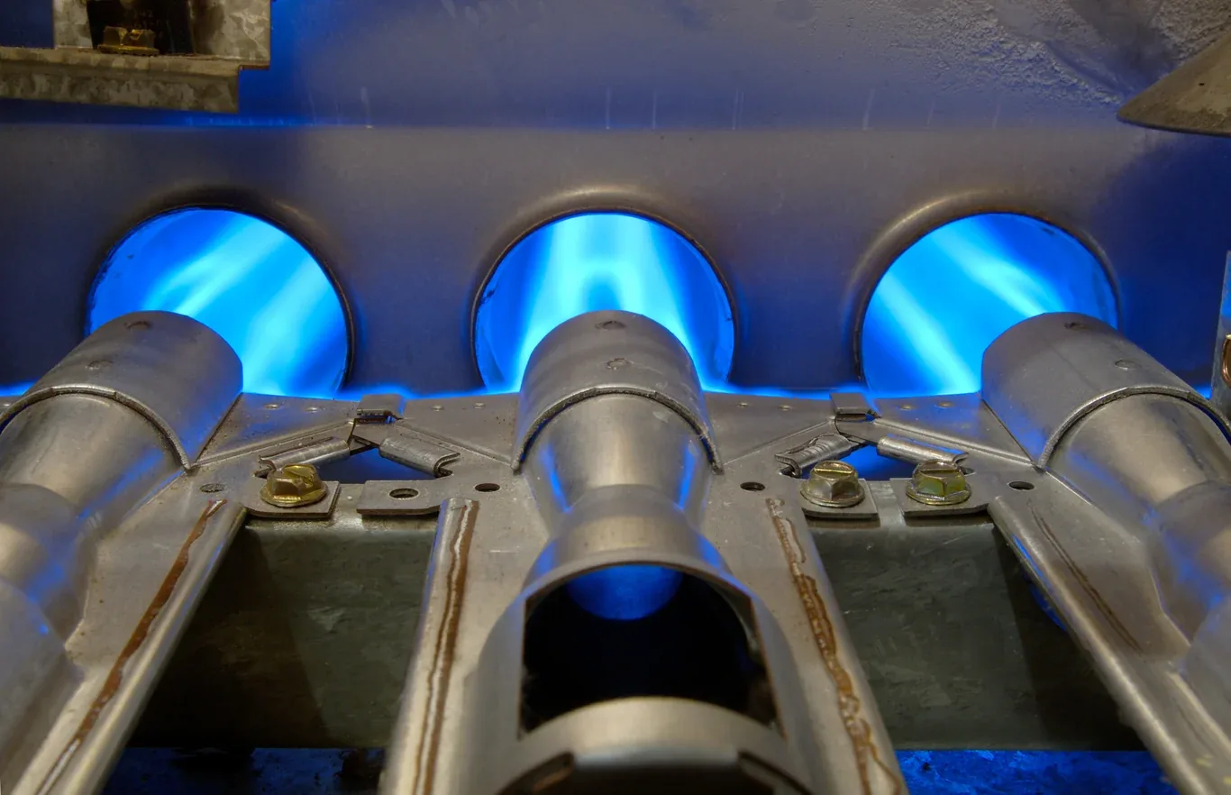 Blue flames burning in a residential gas furnace