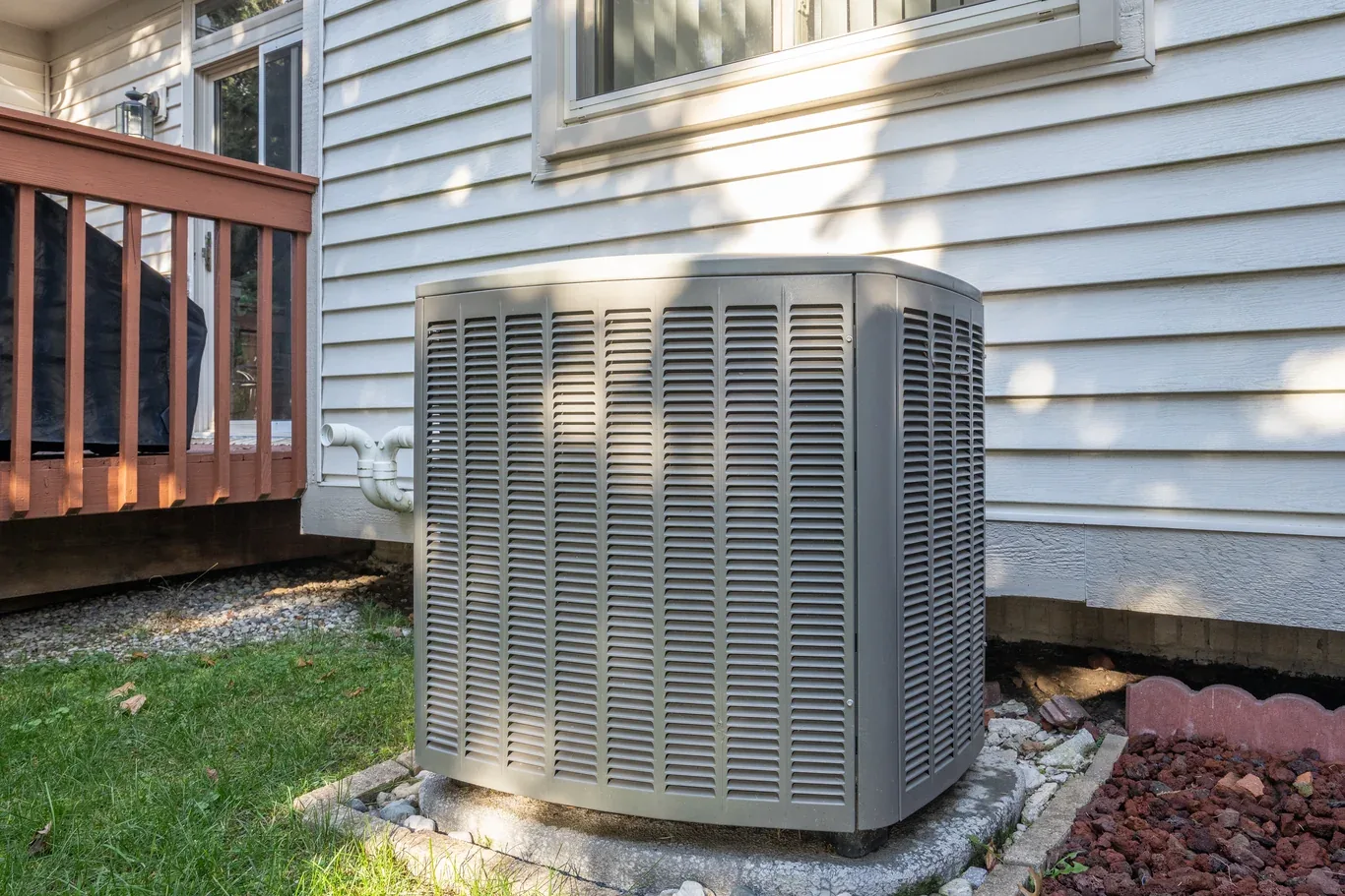 Residential air conditioner unit installed beside a house