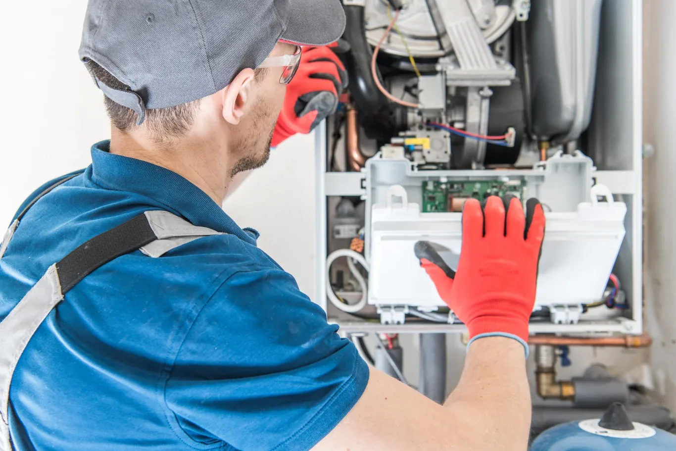 Technician servicing a gas furnace during a tune-up