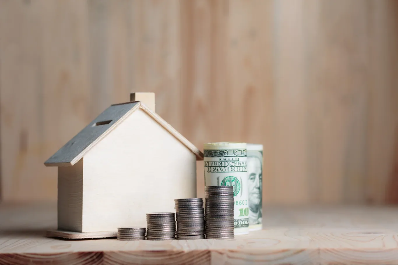 Model house with coins representing HVAC replacement savings